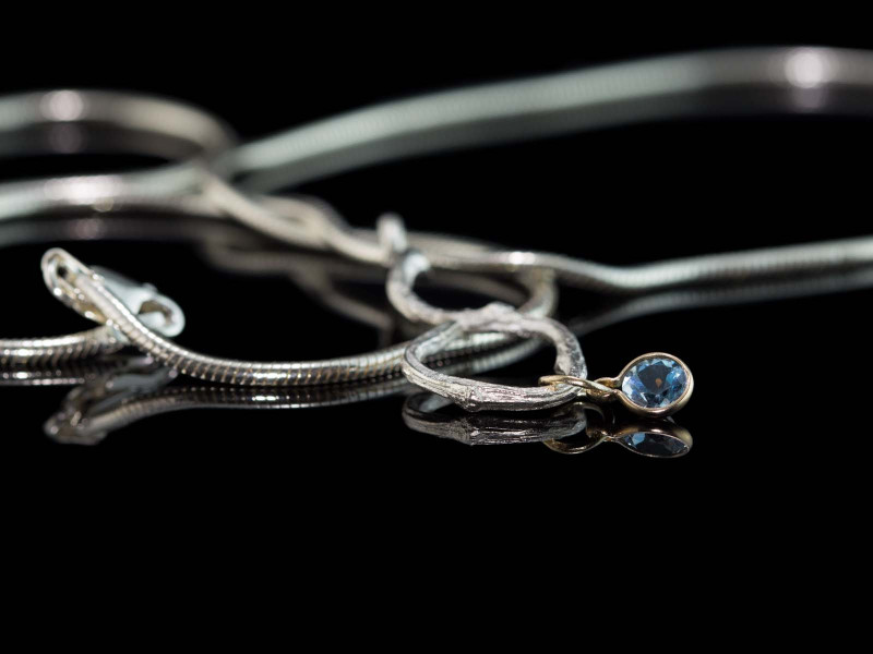 Necklace with Twig cast in Silver with 9ct Gold pendant holding a faceted Aquamarine (sold out)